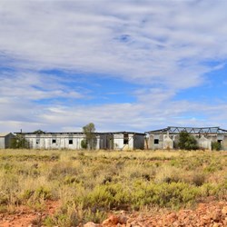 Abandoned buildings in outback landscape