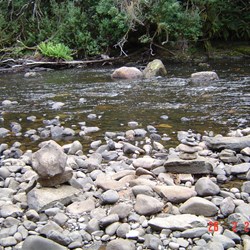 Hellyer Gorge with stone piles and the river