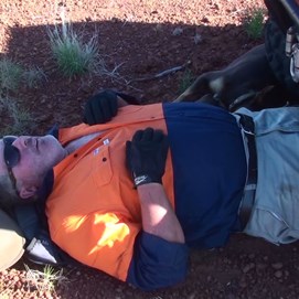 Mick & Massie taking a break in the only shade available - The laterite rise at the halfway mark
