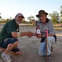 John T presents Peter with a bottle of wine. Winner of the horseshoes game one afternoon.