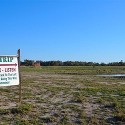 warning sign at the end of the well used airstrip