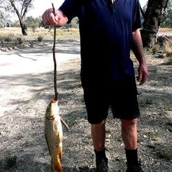 John with one of the carp he caught..
