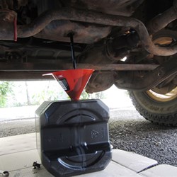 Step 3.  Put a funnel in the tap hole and drain the sump