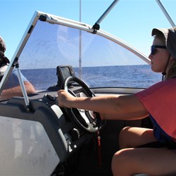 Chardae driving the boat offshore Ningaloo Reef in 33m
