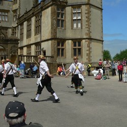 Morrismen dance in front of the new Sherborne Castle