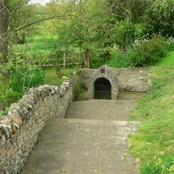 A path leads down to the holy well.