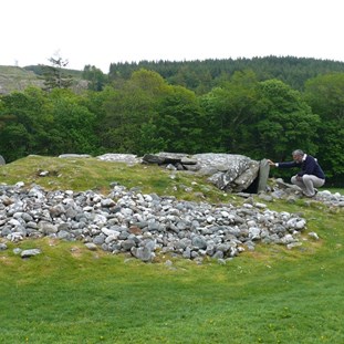 Inspecting a neolithic burial mound in Kilmartin Glen, Scotland