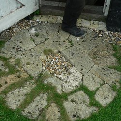 An old grinding stone makes a good threshold now.