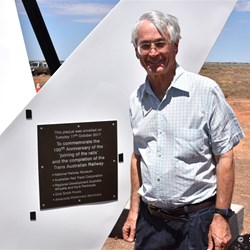 Dick Smith proudly stand along side the new plaque on the Memorial