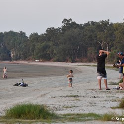 As the sun sets at Weipa, crowds gather on the beach to witness this great event