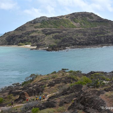 A group of walkers taking the path back towards the beach 