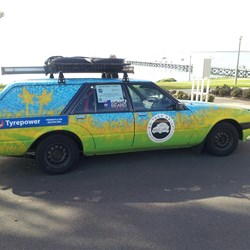 Henry out front of the Streaky Bay Hotel with the jetty in the background, and fuel puddle underneath.