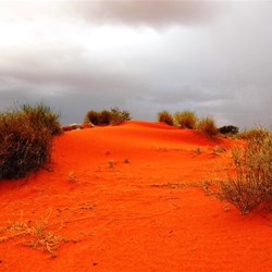 Red sand against a grey sky