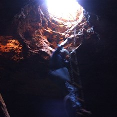 Hugh climbing down into the spring