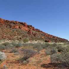 The northern face of the Calvert Range, low jagged and worn.