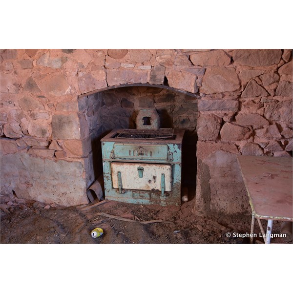 The old wood stove is still in the ruin