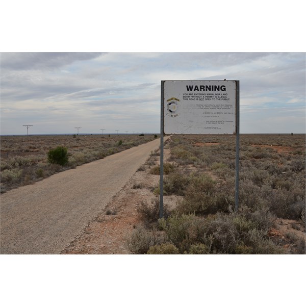 The bitumen road and sign after Watson, heading north for Maralinga