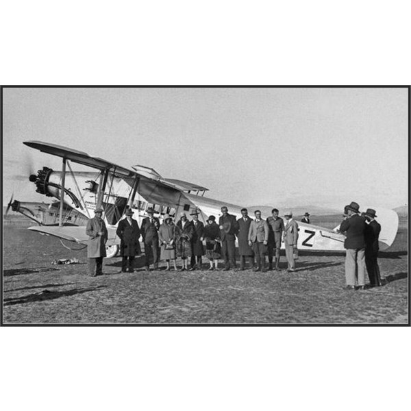 The team, including Frank Neale (fourth from right) and Donald Mackay (fifth from right) poses before VH-UEZ Diamond Bird in Canberra
