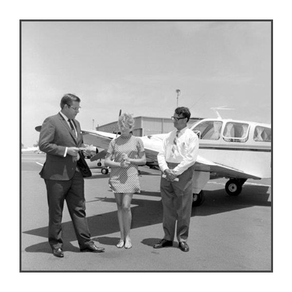 Robin Miller and two men near the aircraft, 1969