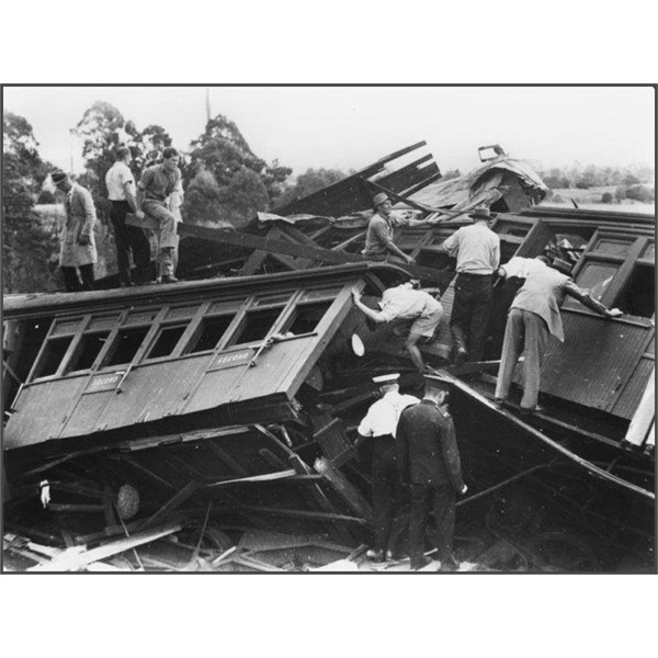 Rescuers inspect the wreckage of the Camp Mountain train disaster