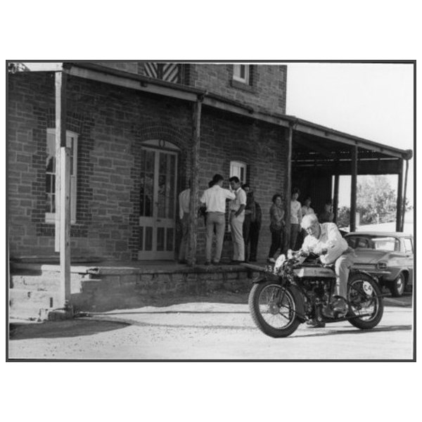 One of the Museum's founders, Jack Kaines, on a Brough Superior motorcycle out the front of the Mill building