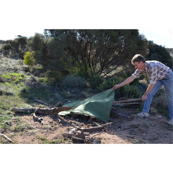 Graeme removing the tarp after its leg was set free