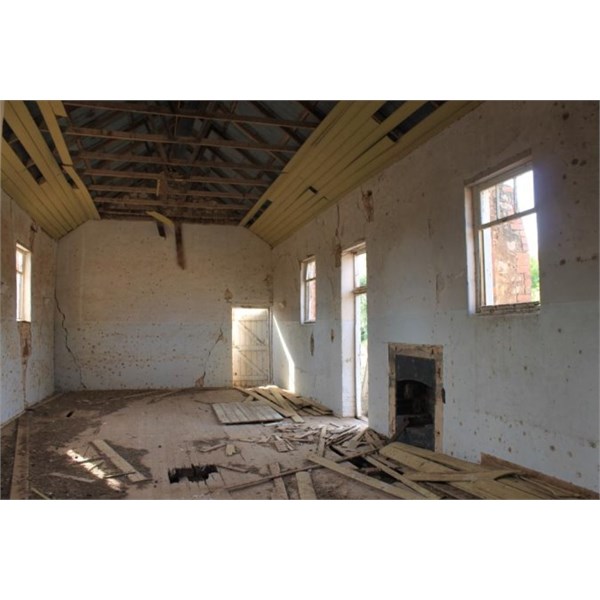 The interior with its fireplace and tongue & groove board ceiling