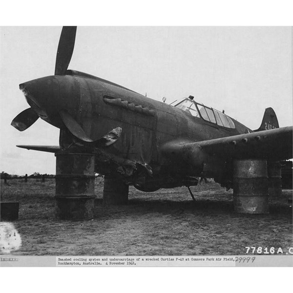 Smashed cooling system and landing gear on a wrecked Curtiss P-40 Kittyhawk at Conners Park Airfield, Rockhampton 1942.