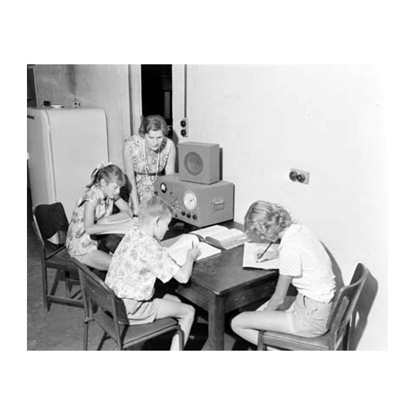 Students  listen to a lesson over the School of the Air in out back NT 1958