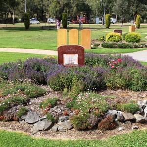 The camping area can be seen behind the flower beds
