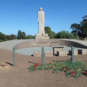 Australian Farmer statue, with blooming Sturt Pea flowers - 30 May 2018