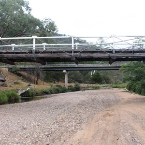 The historic timber suspension bridge beside its concrete replacement