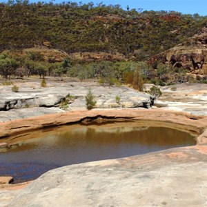 Flood waters have washed large holes in the rocks