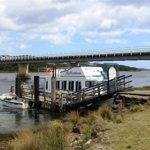 A cruise boat and the bridge that spans the river at the town.