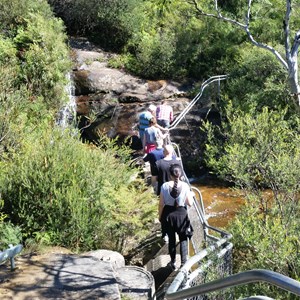 Walkers crossing the top of the falls