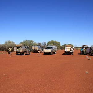 Vehicles parked at eastern end of runway - Hunt Oil Camp airstrip