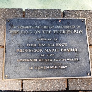 The plaque mounted on the edge of the pool.